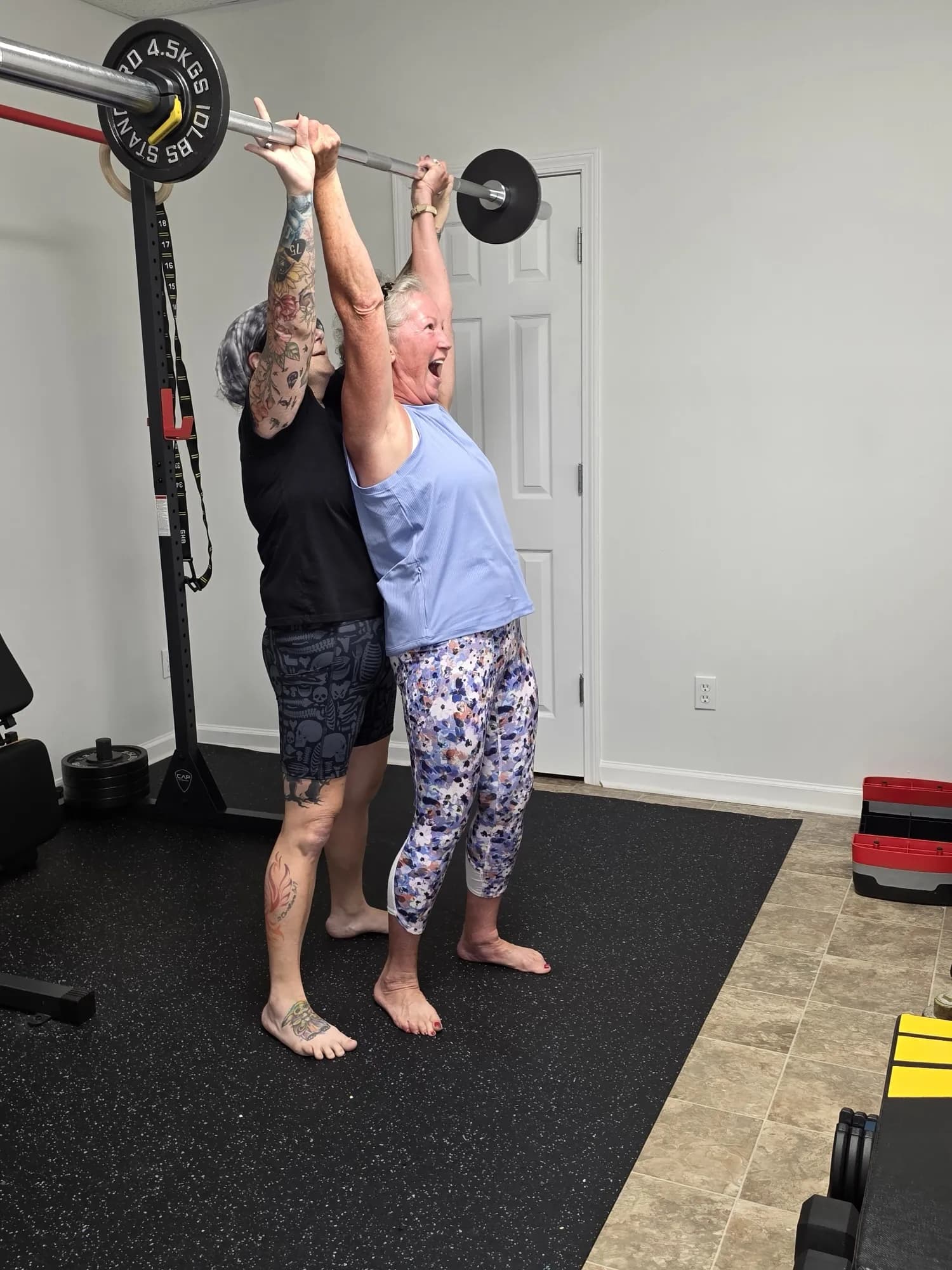 Aviva Mitchell spotting a barbell press