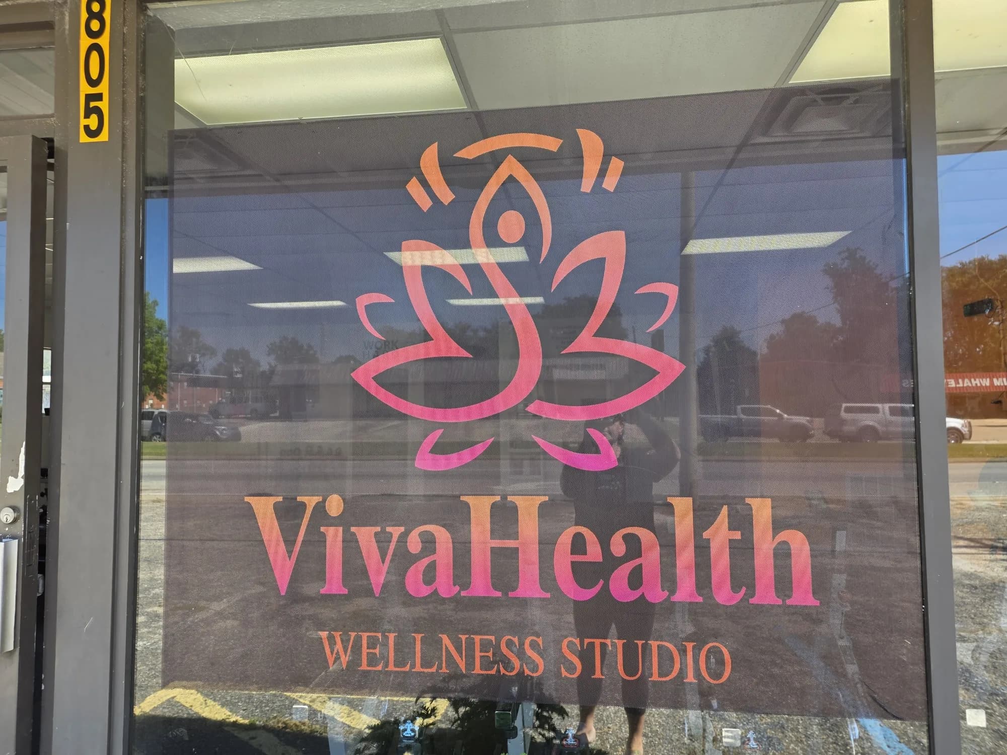 The VivaHealth Wellness Studio logo on the front window at 805 South Eufaula Avenue